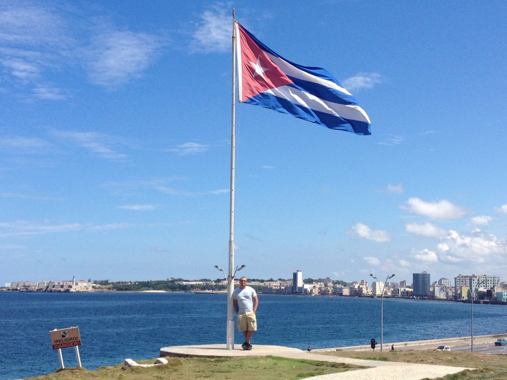Cuban flag and I over the Malecon in Havana