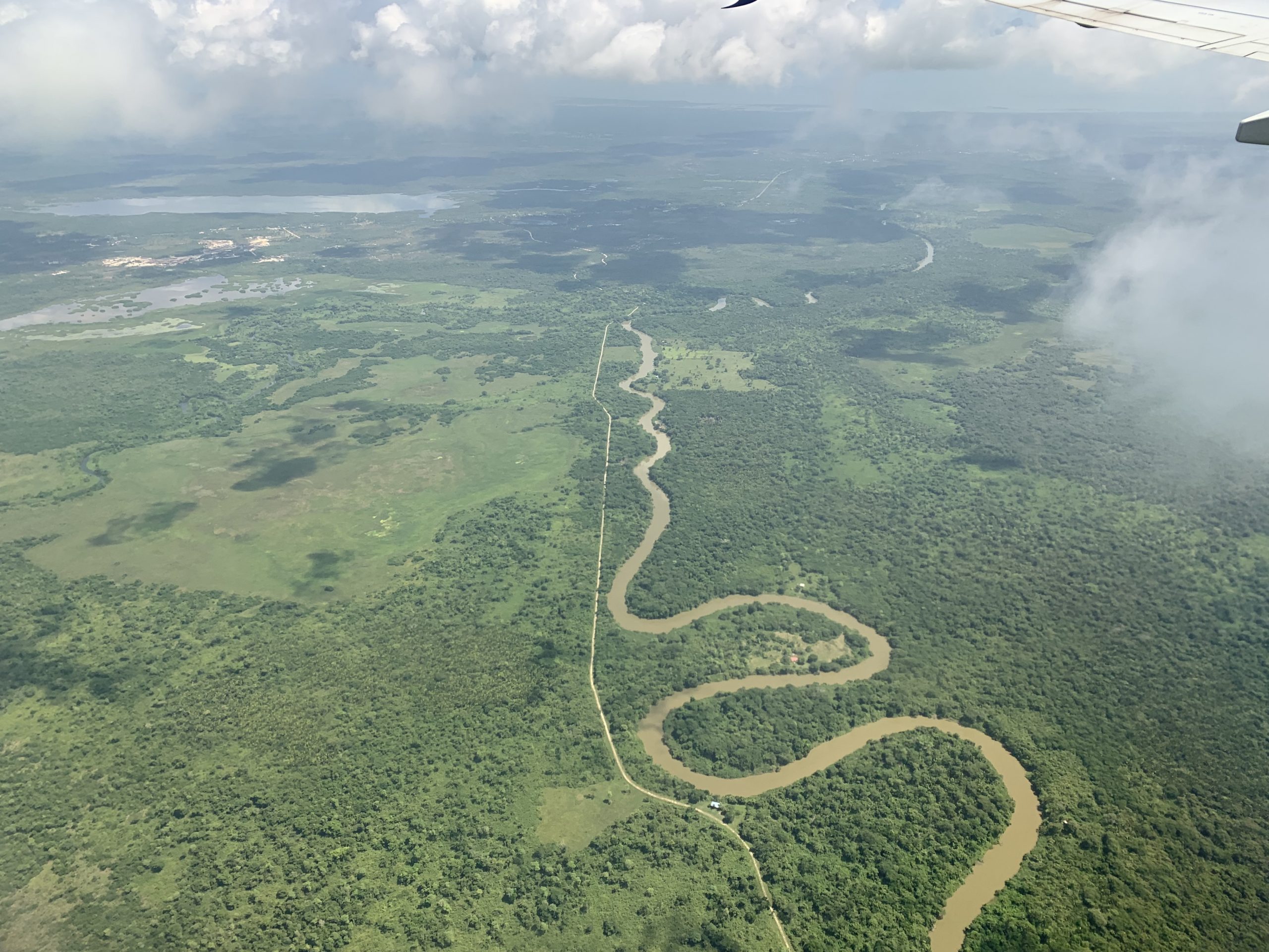 plane arrival over river and green landscape in belize central america