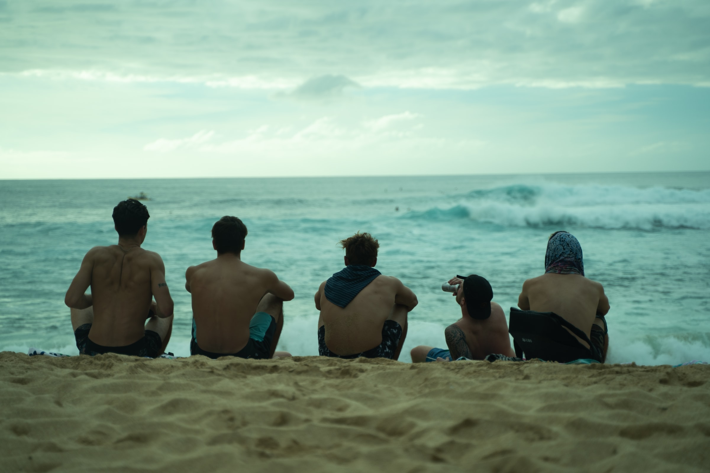 friends hanging out on the beach hawaii