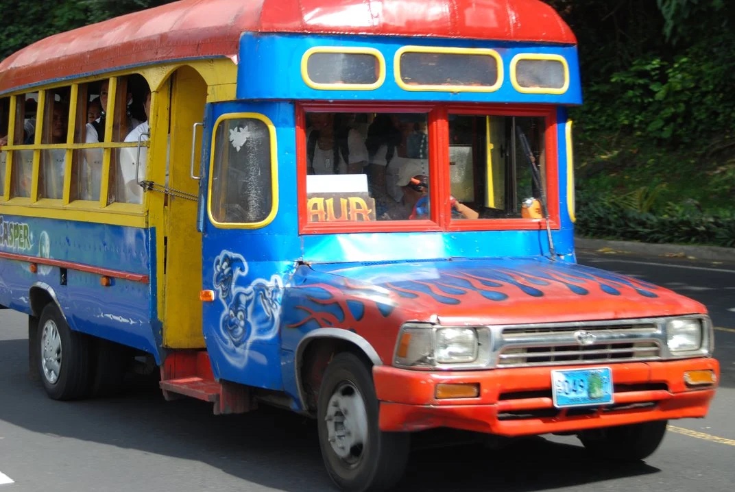 American Samoa Bus: A colorful local bus navigating the scenic roads of the island, adorned with vibrant traditional Polynesian patterns and cultural motifs.