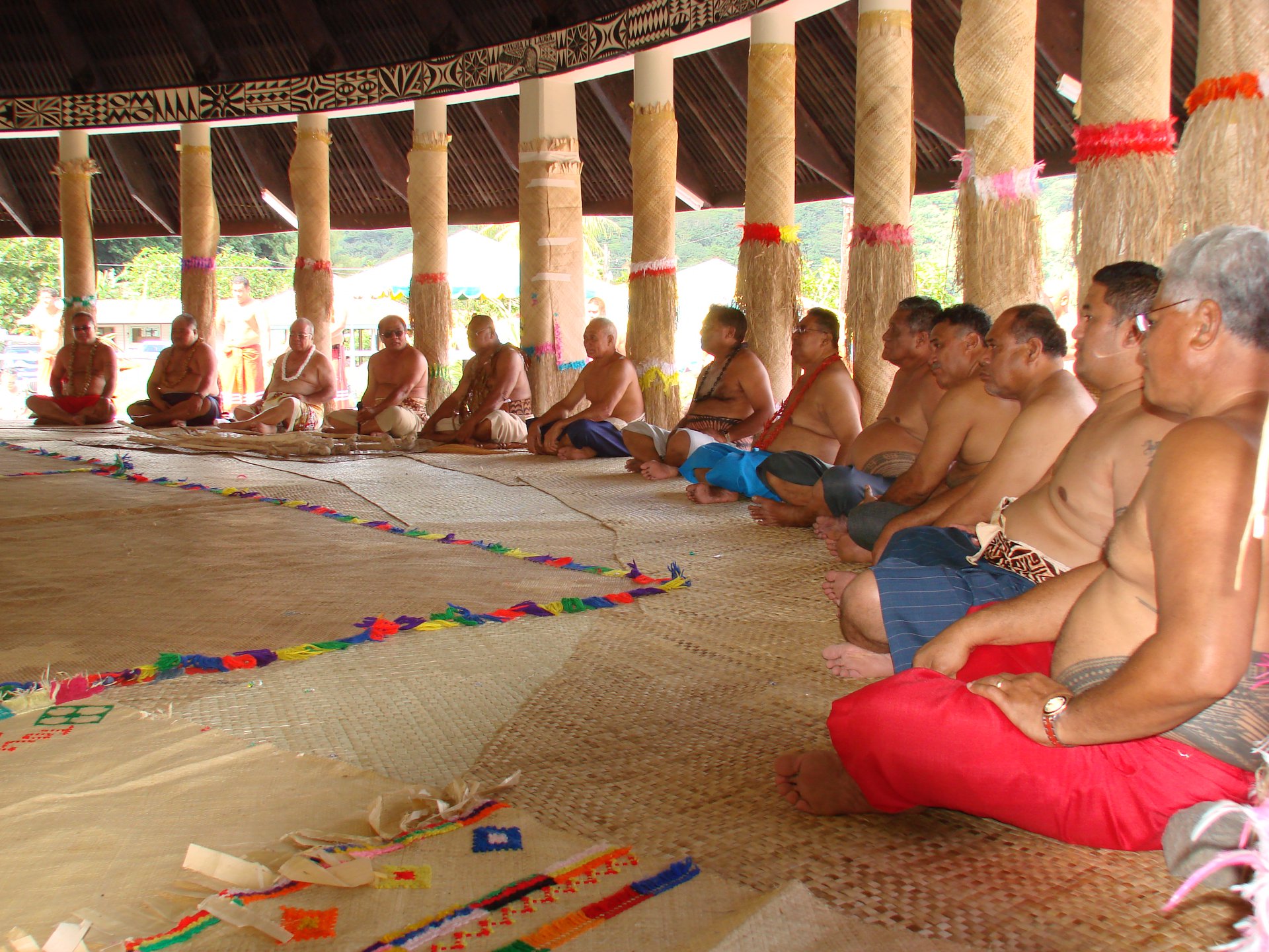 Chiefs gathered in a traditional Samoan fale for a significant meeting.