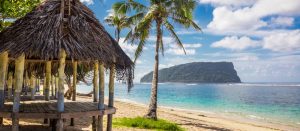 beach fale in the Samoan islands with an island in the background