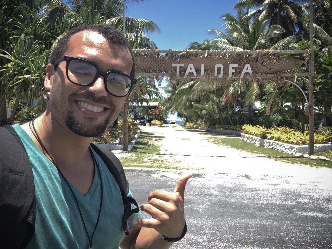 throwing shaka in front of Talofa sign in funafuti tuvalu