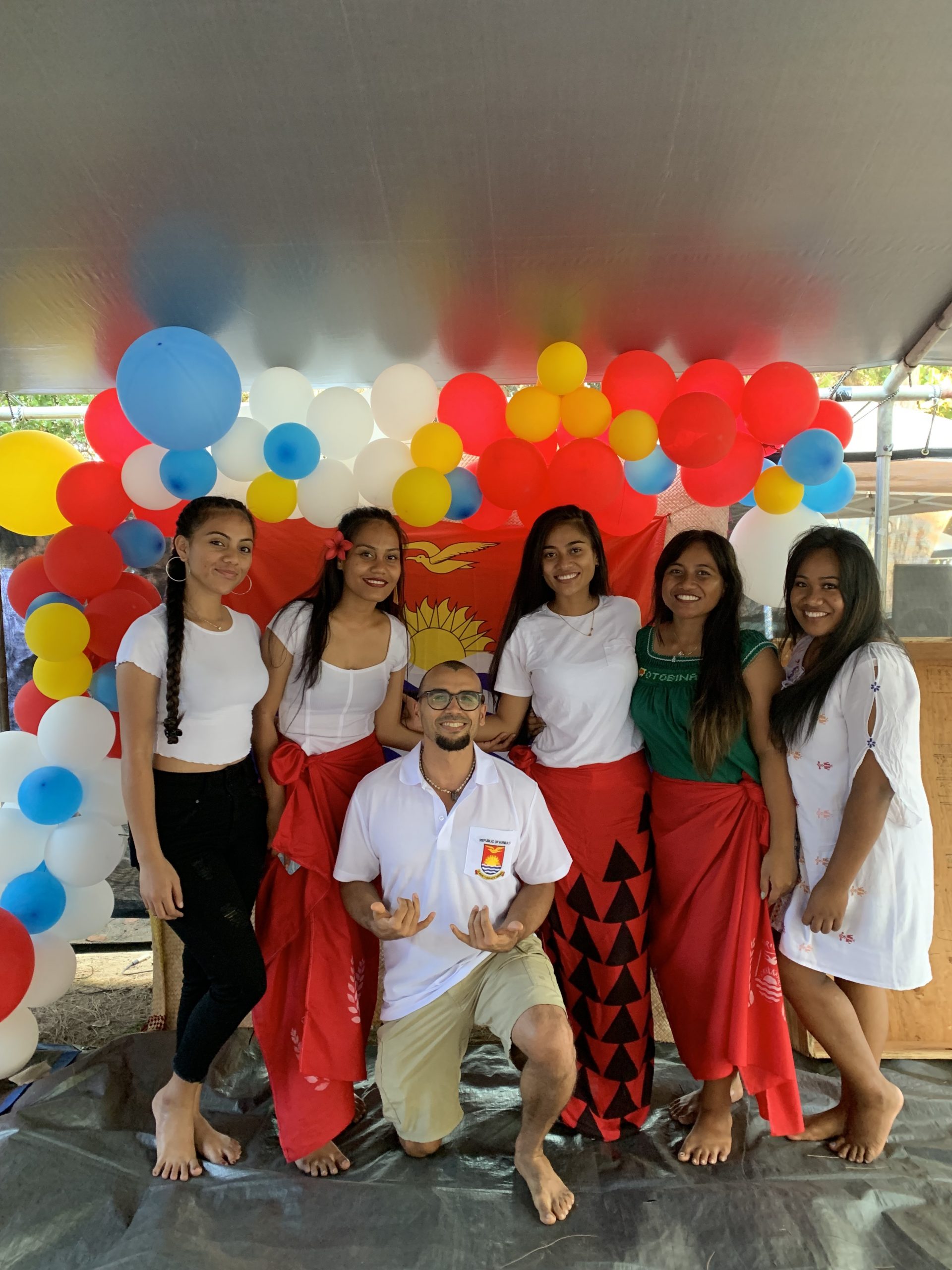 photo with girls from kiribati and flag